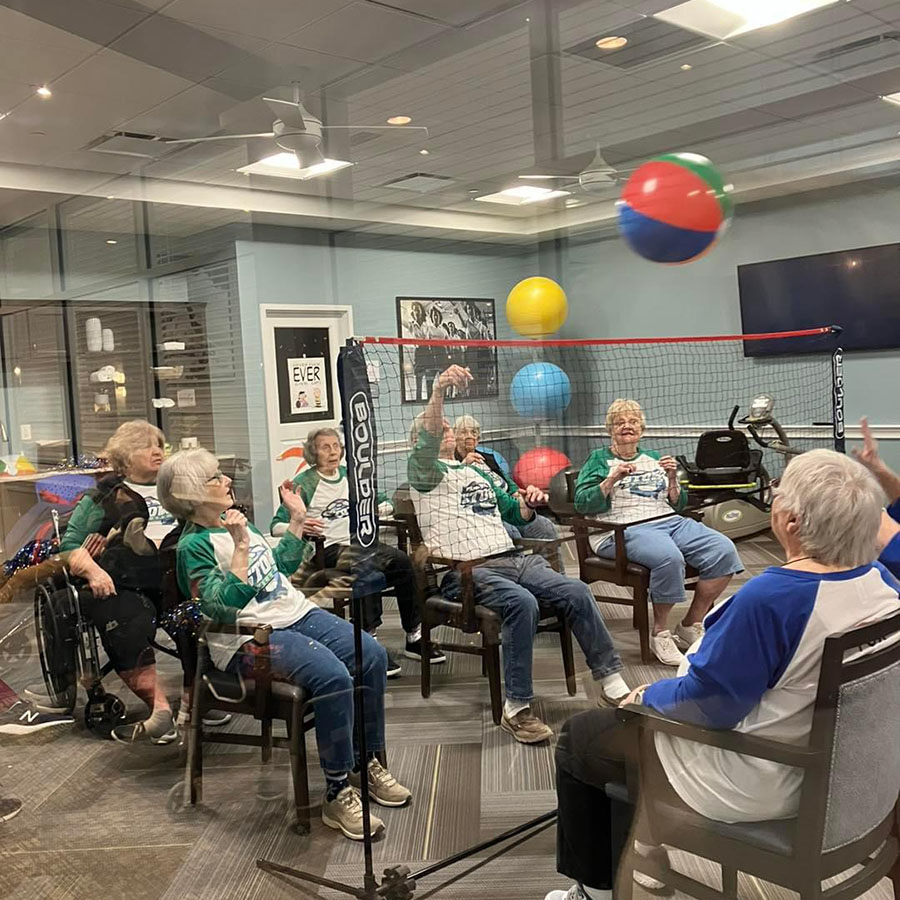 Chair volleyball for new employees: senior residents bond over a fun beachball game.