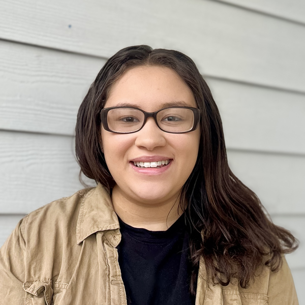 Jayden Graves, Memory Care Director at Vitalia Stow, smiling in front of a light gray siding background.