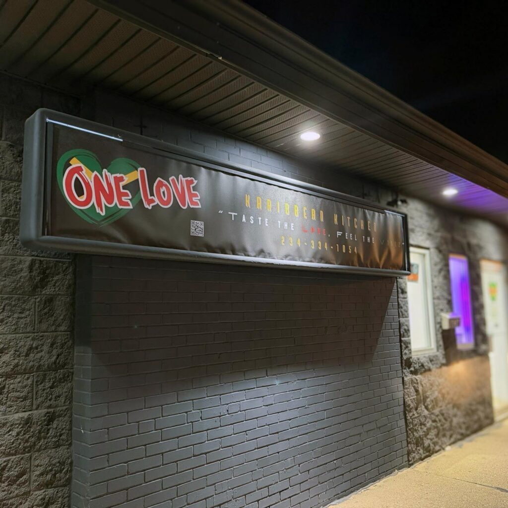 The sign and storefront of One Love Karibbean Kitchen.